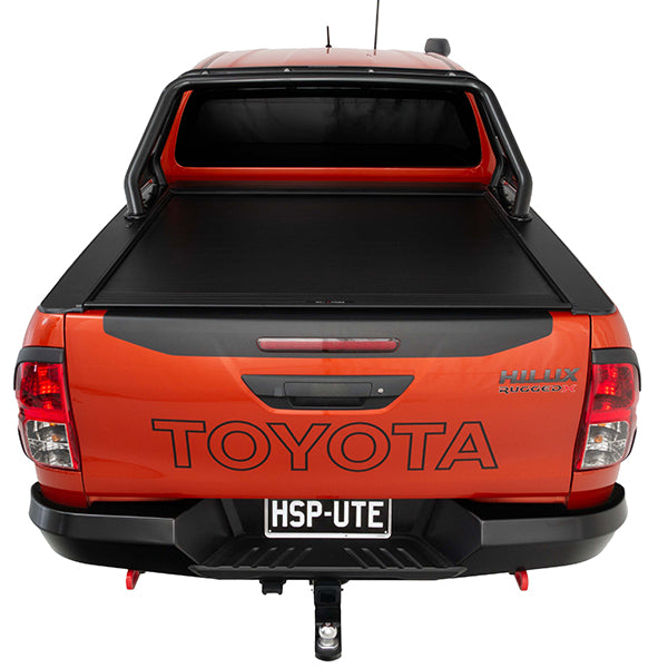 Rear view of orange Toyota Hilux Rugged X with HSP Roll Top and HSP Roller Cover closed