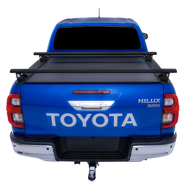 Blue Toyota Hilux SR5 with HSP roller cover closed and load bars fitted straight rear view
