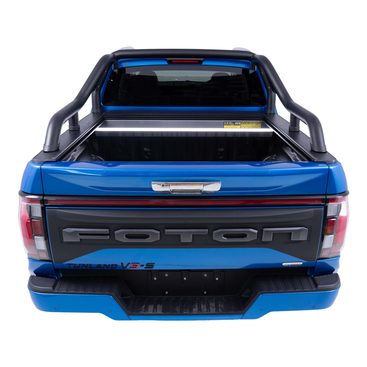 Rear view of a dark blue Foton Tunland ute with a open Roll top shutter, in a studio setting