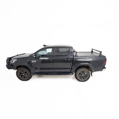 HSP Load Rack JNR fitted to black Toyota Hilux dual cab, side profile view showing compact rack over closed HSP Roller Cover